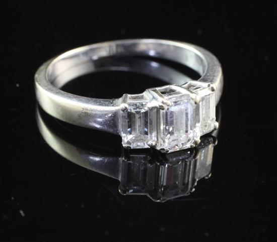 An 18ct white gold and three stone diamond ring, size M.